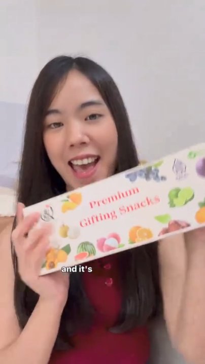 Creator holding up the Everything Good Premium Gifting Snacks box